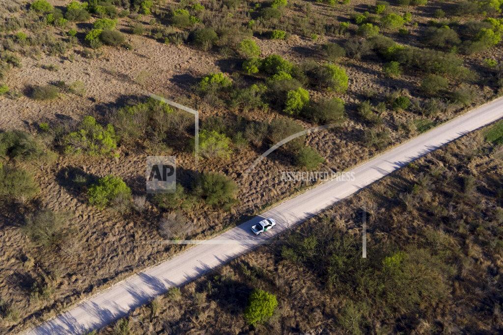 Julio Cortez In this photo taken by a drone, a U.S. Customs and Border Protection vehicle rides along a dirt road near the U.S.-Mexico border, Thursday, March 18, 2021, in Mission, Texas. A surge of migrants on the Southwest border has the Biden administration on the defensive. The head of Homeland Security acknowledged the severity of the problem Tuesday but insisted it's under control and said he won't revive a Trump-era practice of immediately expelling teens and children. (AP Photo/Julio Cortez)
