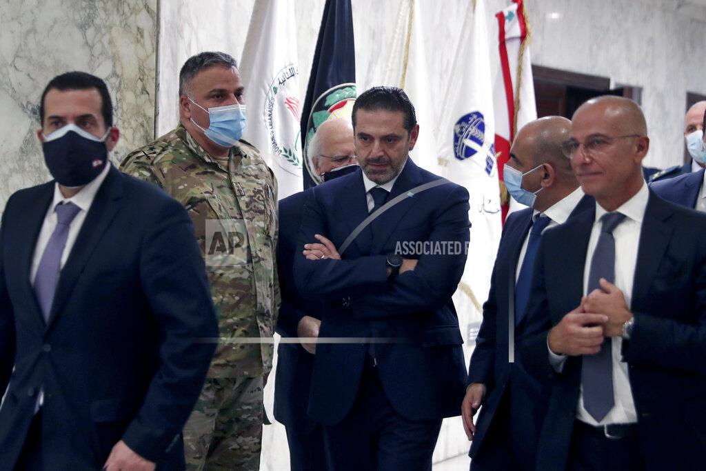 Bilal Hussein Lebanese Prime Minister-Designate Saad Hariri, center, walks after his meeting with Lebanese President Michel Aoun, at the Presidential Palace in Baabda, east of Beirut, Lebanon, Thursday, March.18, 2021. Hariri said despite disagreements with the country's president there is still a chance to form a government to halt economic collapse and offer people hope. (AP Photo/Bilal Hussein)