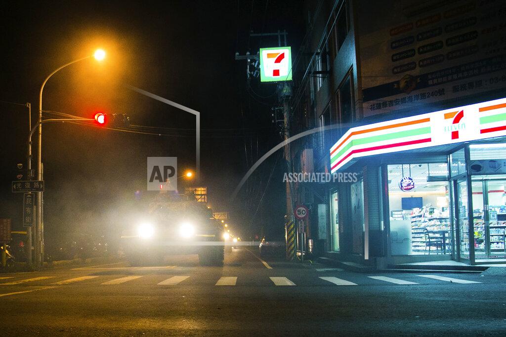 Uncredited In this photo released by the Military News Agency, a tank rolls past a convenience store as it prepares to take part in the annual Han Kuang live-fire drills in Hualian, eastern Taiwan in the early hours of Tuesday, Sept. 14, 2021. (Military News Agency via AP)
