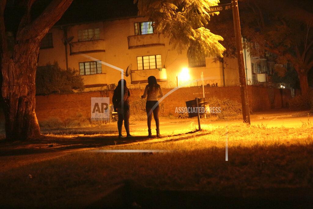 Tsvangirayi Mukwazhi Sex workers wait for clients in the red light district of Harare, Zimbabwe, Friday, June 12, 2020. As the coronavirus spreads in Africa, it increasingly threatens those who earn their living on the streets, including sex workers with HIV. (AP Photo/Tsvangirayi Mukwazhi)