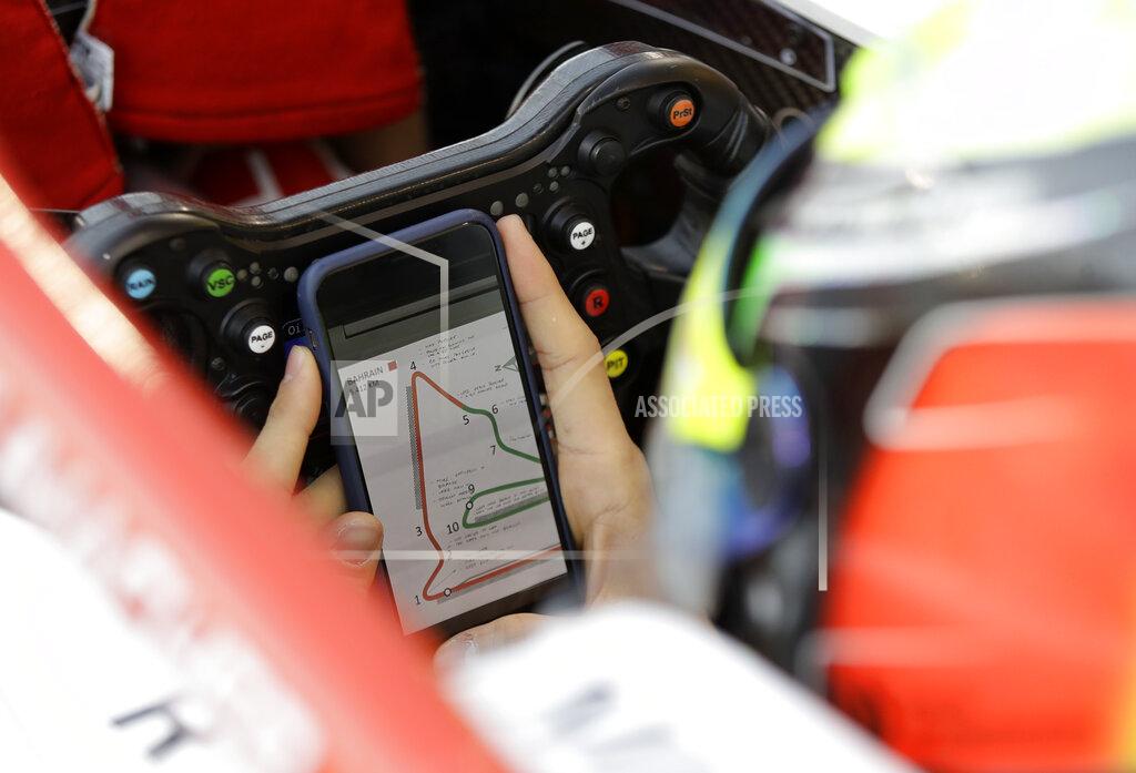 Luca Bruno Formula 2 driver Mick Schumacher prepares in the garage of Prema racing team car, during the Formula 2 qualifying session at the Bahrain International Circuit in Sakhir, Bahrain, Friday, March 29, 2019. It promises to be a whirlwind few days for the son of Formula One great Michael Schumacher, as he makes his F2 debut this weekend and then drives in his first F1 test for Ferrari on Tuesday. (AP Photo/Luca Bruno)