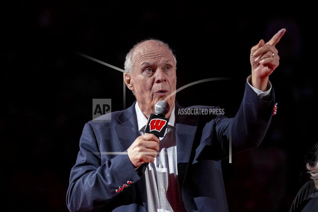 Andy Manis Bo Ryan, a former Wisconsin basketball coach, gestures during a ceremony to celebrate his 15 seasons as coach, at halftime of the team's NCAA college basketball game against Wisconsin-Green Bay on Friday, Nov. 12, 2021, in Madison, Wis. Ryan led Wisconsin to a school-record of 364 wins in 15 seasons. (AP Photo/Andy Manis)