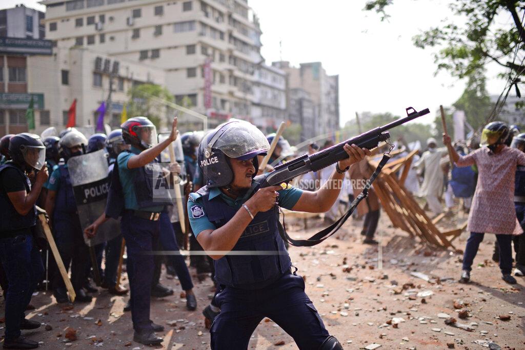Mahmud Hossain Opu Security officers disperse demonstrators protesting against the visit of Indian Prime Minister Narendra Modi after Friday prayers at Baitul Mokarram mosque in Dhaka, Bangladesh, Friday, March 26, 2021. Witnesses said violent clashes broke out after one faction of protesters began waving their shoes as a sign of disrespect to Indian Prime Minister Narendra Modi, and another group tried to stop them. Local media said the protesters who tried to stop the shoe-waving are aligned with the ruling Awami League party. The party criticized the other protest faction for attempting to create chaos in the country during Modi’s visit. (AP Photo/Mahmud Hossain Opu)