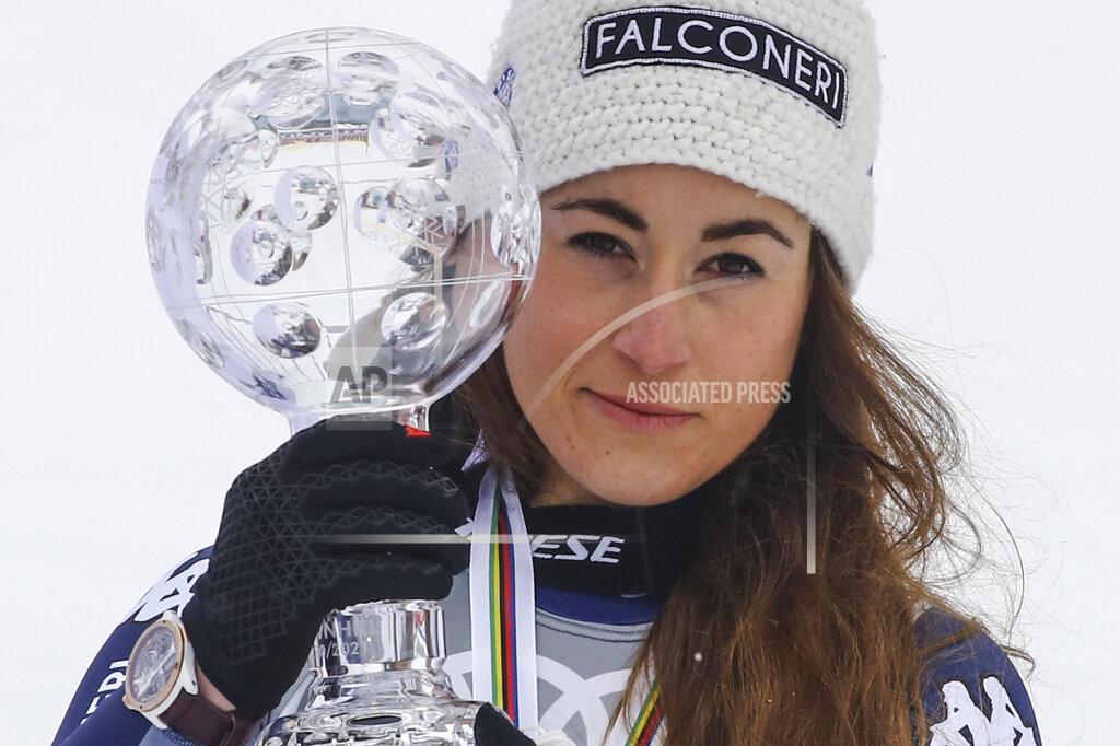 Marco Trovati Italy's Sofia Goggia poses with the trophy of the alpine ski, women's World Cup downhill, in Lenzerheide, Switzerland, Wednesday, March 17, 2021. (AP Photo/Marco Trovati)