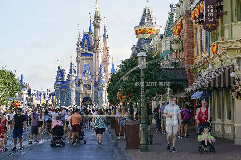 John Raoux Guests stroll along Main Street at the Magic Kingdom theme park at Walt Disney World Monday, Aug. 30, 2021, in Lake Buena Vista, Fla. The park will celebrate its 50th anniversary on Oct. 1. (AP Photo/John Raoux)