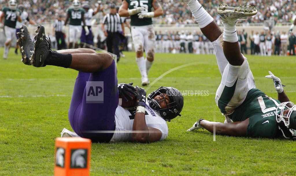 Al Goldis Northwestern's Cameron Green, left, comes down with a touchdown against Michigan State's Tyriq Thompson during the third quarter of an NCAA college football game, Saturday, Oct. 6, 2018, in East Lansing, Mich. Northwestern won 29-19. (AP Photo/Al Goldis)