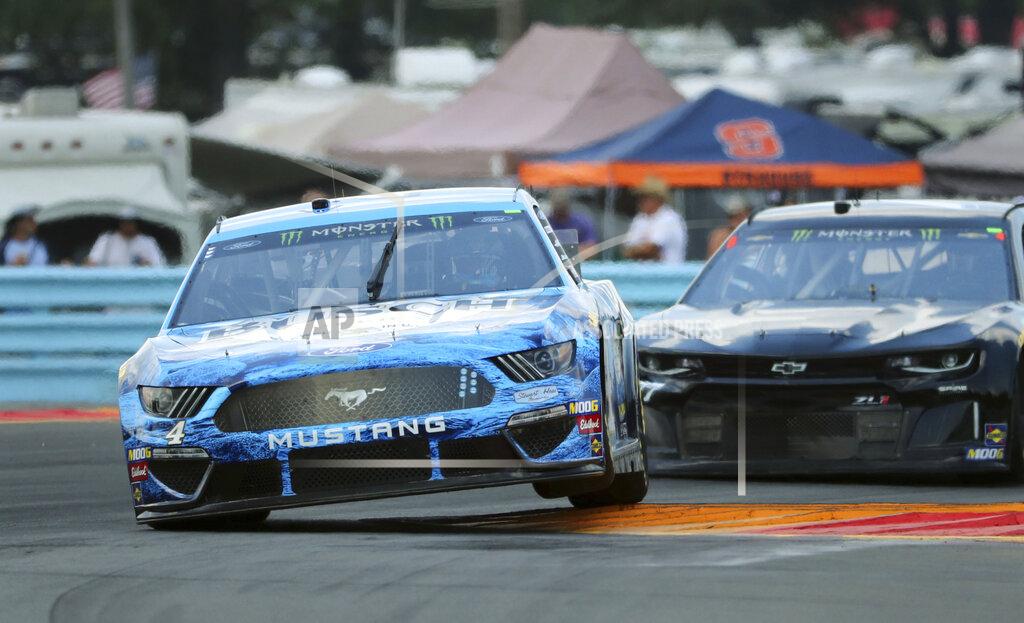 John Munson Kevin Harvik (4) heads through the area known as "The Bus Stop" during a practice run for a NASCAR Cup Series auto race at Watkins Glen International, Saturday, Aug. 3, 2019, in Watkins Glen, N.Y. (AP Photo/John Munson)