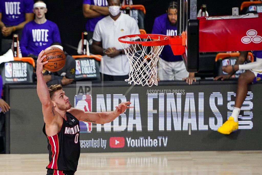 Mark J. Terrill FILE - In this Oct. 4, 2020, file photo, Miami Heat's Meyers Leonard (0) shoots against the Los Angeles Lakers during the second half in Game 3 of basketball's NBA Finals in Lake Buena Vista, Fla. Leonard and Goran Dragic have both decided to return to the Eastern Conference champions, each telling The Associated Press on Friday evening, Nov. 20, 2020, that they have agreed to accept Miami’s offer of two-year deals -- the second year is a team option on both contracts -- to remain with the Heat. (AP Photo/Mark J. Terrill)
