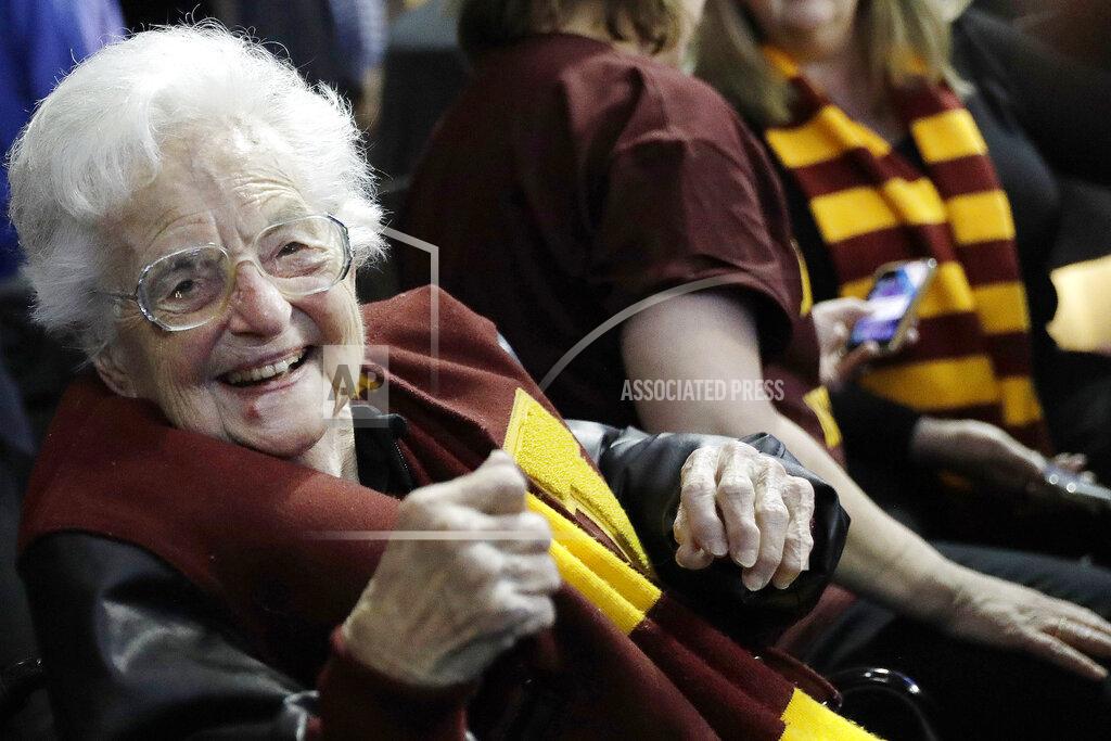 FILE - In this March 22, 2018 file photo, Sister Jean Dolores Schmidt sits with other Loyola-Chicago fans during the first half of a regional semifinal NCAA college basketball game against Nevada in Atlanta. Even to Sister Jean, the lovable nonagenarian nun who became a star during Loyola Chicago's stunning run to the Final Four two years ago, this is new territory. The COVID-19 pandemic has brought big chunks of the world to a near standstill. And at 100 years old, this is new territory for Sister Jean Dolores Schmidt. (AP Photo/David Goldman, File)