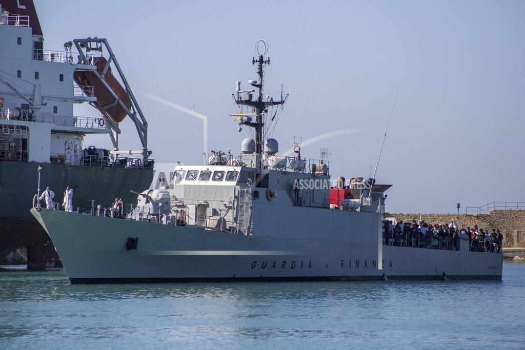 Fabio Peonia Migrants arrive in Porto Empedocle, Sicily, aboard two military ships after being transferred from the island of Lampedusa, where a number of small boat carrying migrants arrived in the last days, Monday, July 27, 2020. (Fabio Peonia/LaPresse via AP)