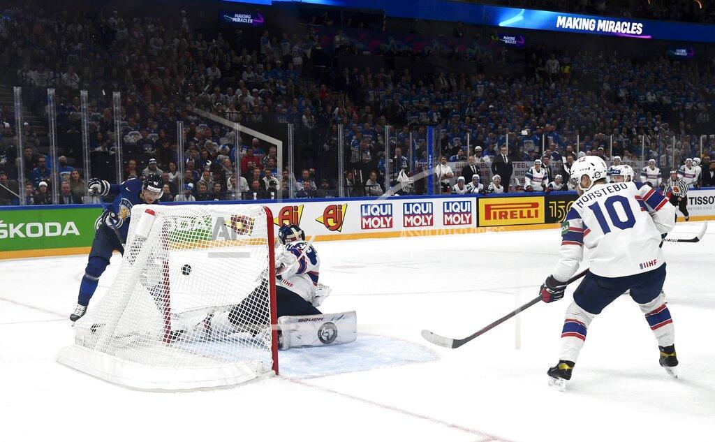 Emmi Korhonen Finland's Harri Pesonen, left, scores past Norway's goalie Henrik Haukeland during their preliminary round group B Hockey World Championship match between Finland and Norway in Tampere, Finland, Friday May 13, 2022. (Emmi Korhonen/Lehtikuva via AP)