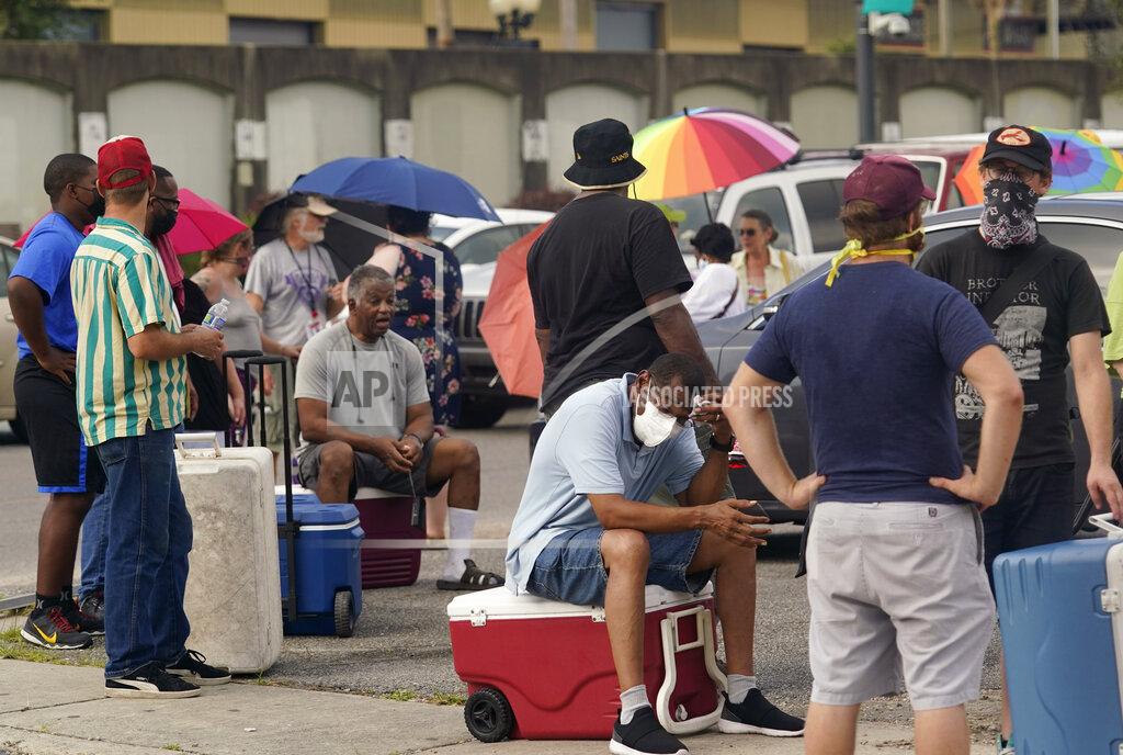Eric Gay Louisiana residents still reeling from flooding and damage caused by Hurricane Ida are scrambling for food, gas, water and relief from the oppressive heat, Wednesday, Sept. 1, 2021, in New Orleans, La. (AP Photo/Eric Gay)