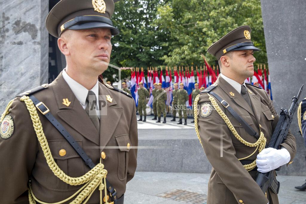 Darko Bandic Croatia's honor guards attend a ceremony in Knin, Croatia, Wednesday, Aug. 5, 2020. Croatia marked the 25th anniversary of a victorious wartime military offensive, with an ethnic Serb politician attending the ceremony for the first time in what is seen as an important step toward reconciliation. (AP Photo/Darko Bandic)
