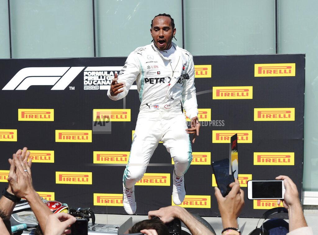 Ryan Remiorz Mercedes driver Lewis Hamilton, of Britain, celebrates after winning Formula One Canadian Grand Prix auto race in Montreal, Sunday, June 9, 2019. (Ryan Remiorz/The Canadian Press via AP)