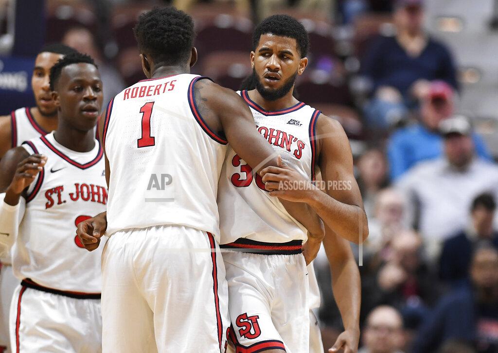 Jessica Hill St. John's LJ Figueroa, right, is congratulated by teammate Josh Roberts during the first half of an NCAA college basketball game against Arizona State, Saturday, Nov. 23, 2019, in Uncasville, Conn. (AP Photo/Jessica Hill)