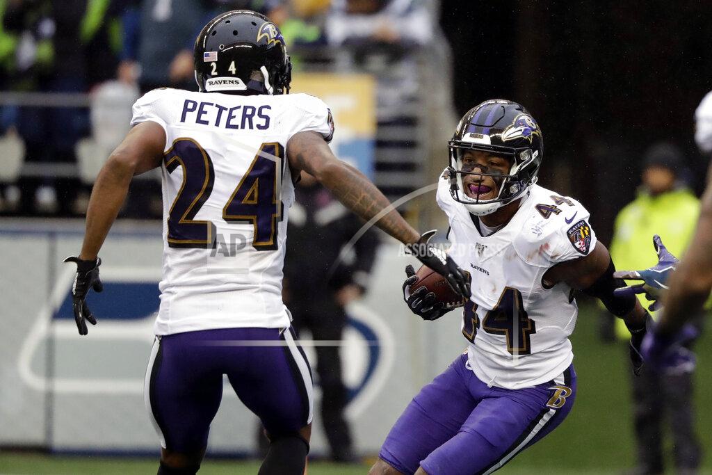 Elaine Thompson Baltimore Ravens cornerback Marlon Humphrey (44) celebrates with cornerback Marcus Peters (24) after recovering a Seattle Seahawks fumble and running for a touchdown during the second half of an NFL football game, Sunday, Oct. 20, 2019, in Seattle. (AP Photo/Elaine Thompson)