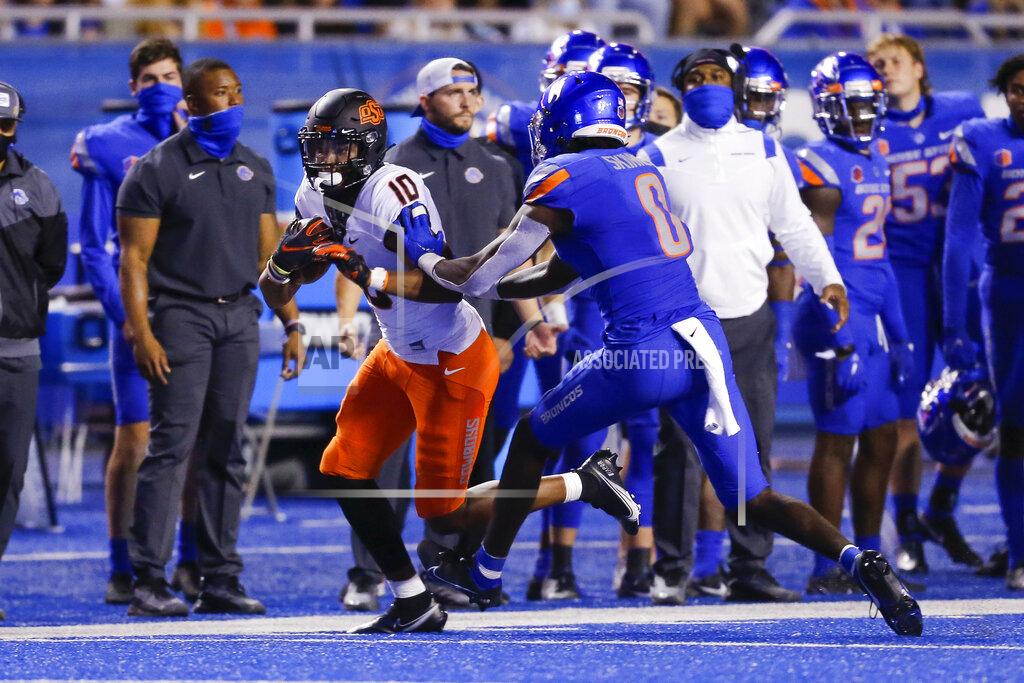 Steve Conner Oklahoma State wide receiver Rashod Owens (10) is pushed out of bounds by Boise State safety JL Skinner (0) during the second half of an NCAA college football game Saturday, Sept. 18, 2021, in Boise, Idaho. (AP Photo/Steve Conner)