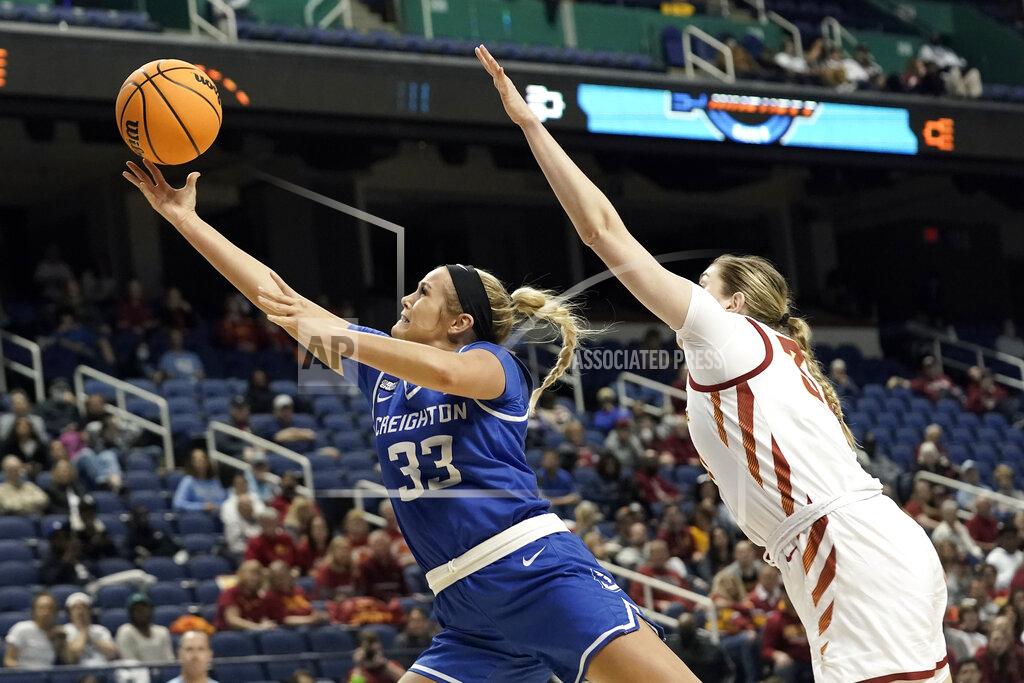 Gerry Broome Creighton guard Payton Brotzki (33) drives to the basket against Creighton forward Emma Ronsiek during the second half of a college basketball game in the Sweet 16 round of the NCAA tournament in Greensboro, N.C., Friday, March 25, 2022. (AP Photo/Gerry Broome)