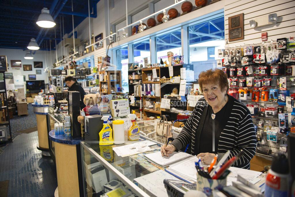 James Poulson Shirley Robards works at the front counter of Stereo North in Sitka, Alaska, on Friday, April 24, 2020. Many Alaskans are cautiously returning to work today following revised state mandates. Robards said the store has done business during the emergency by delivering goods. (James Poulson/The Daily Sitka Sentinel via AP)