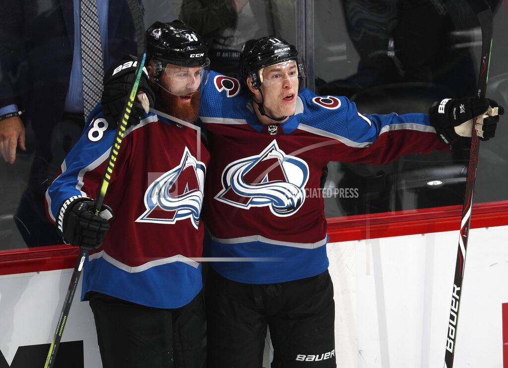 Colorado Avalanche left wing Matt Calvert, right, celebrates his goal with defenseman Ian Cole during the first period of the team's NHL hockey game against the Vegas Golden Knights on Wednesday, March 27, 2019, in Denver. (AP Photo/David Zalubowski)