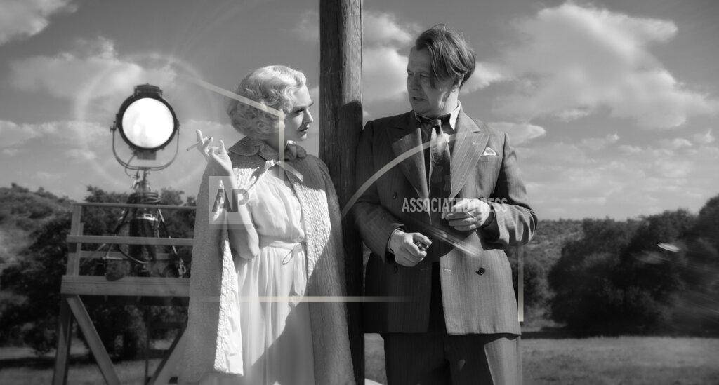 Uncredited In this image released by Netflix, Amanda Seyfried, left, and Gary Oldman appear in a scene from "Mank." (Netflix via AP)