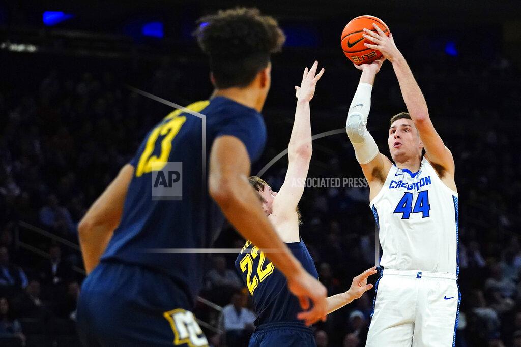 Frank Franklin Ii Creighton's Ryan Hawkins (44) shoots over Marquette's Tyler Kolek (22) and Oso Ighodaro (13) during the first half of an NCAA college basketball game at the Big East conference tournament Thursday, March 10, 2022, in New York. (AP Photo/Frank Franklin II)