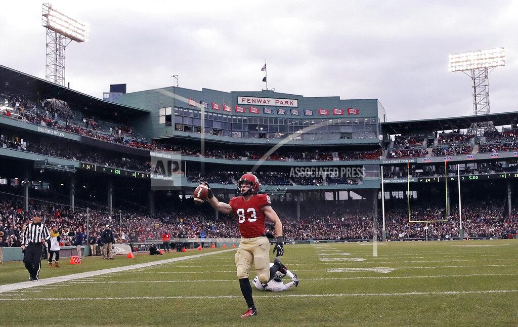 Charles Krupa FILE - In this Nov. 17, 2018, file photo, Harvard wide receiver Jack Cook (83) raises the ball after crossing the goal line for a touchdown against Yale during the second half of an NCAA college football game at Fenway Park in Boston. The Ivy League has canceled all fall sports because of the coronavirus pandemic. (AP Photo/Charles Krupa, File)