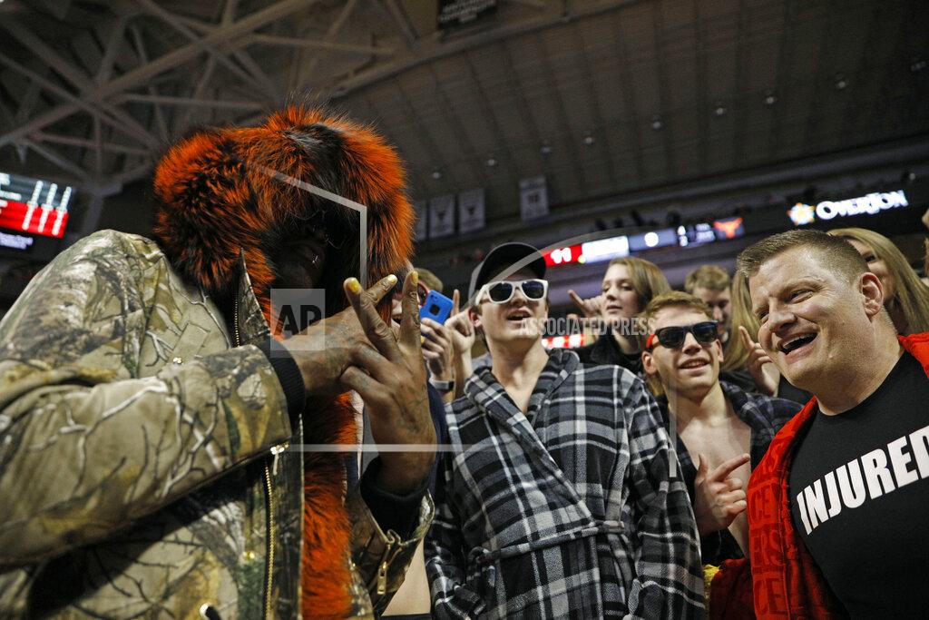 Brad Tollefson Dennis Rodman, left, cheers with Texas Tech fans during the first half of an NCAA college basketball game against Texas, Monday, March 4, 2019, in Lubbock, Texas. (AP Photo/Brad Tollefson)