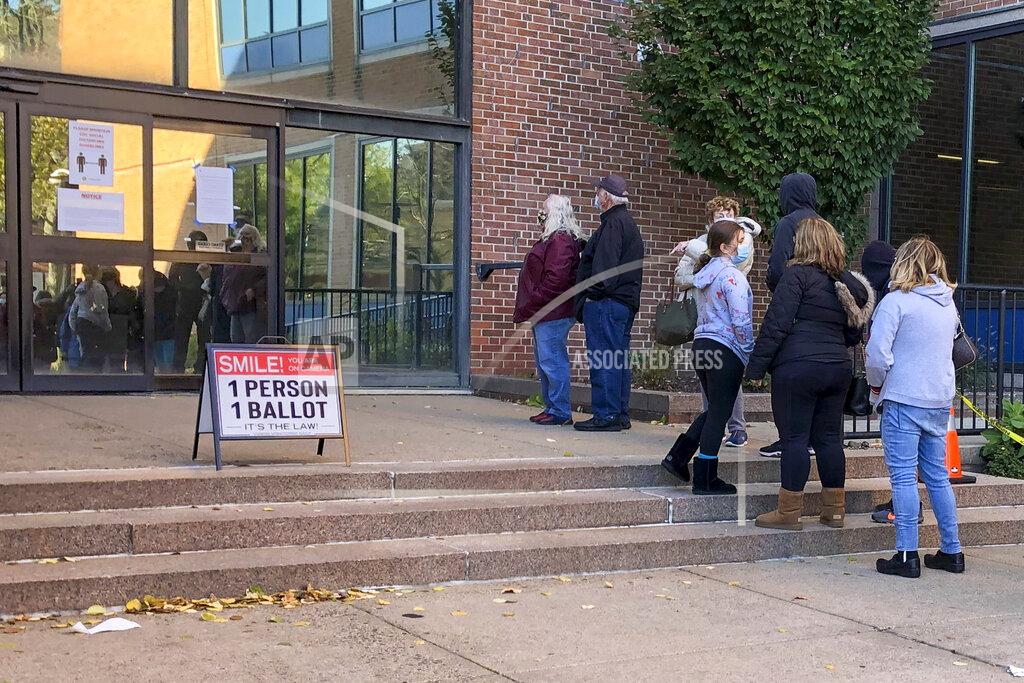 Voters wait in line outside the Bucks county government building in Doylestown, Pa., a suburb of Philadelphia, on Monday, Nov. 2, 2020. Some said they received word that their mail-in ballots had problems and needed to be fixed in order to count. (AP Photo/Mike Catalini)