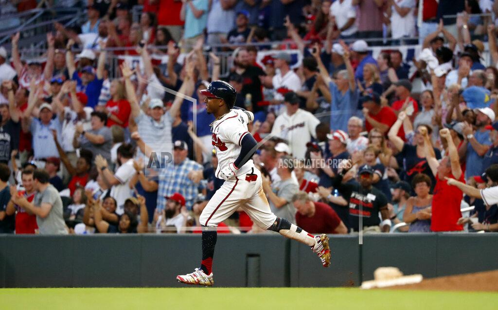 John Bazemore FILE - In this July 4, 2019, file photo, Atlanta Braves' Ozzie Albies rounds first base after hitting a three-run home run during the third inning of the team's baseball game against the Philadelphia Phillies in Atlanta. Major League Baseball owners gave the go-ahead Monday, May 11, 2020, to making a proposal to the players’ union that could lead to the coronavirus-delayed season starting around the Fourth of July weekend in ballparks without fans, a plan that envisioned expanding the designated hitter to the National League for 2020. (AP Photo/John Bazemore, File)