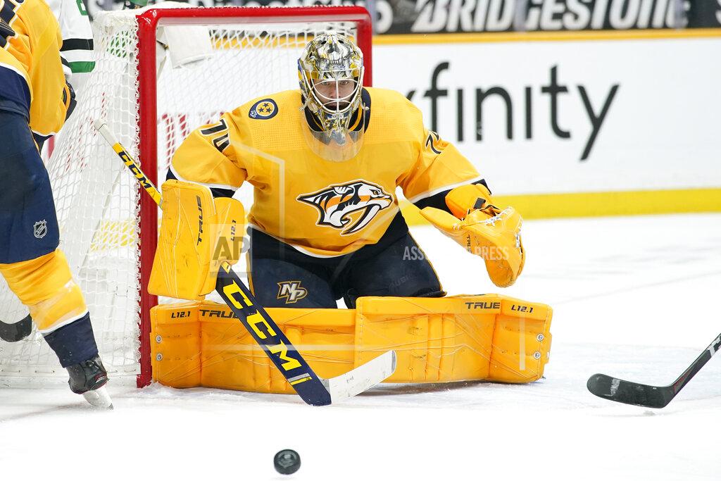 Mark Humphrey FILE - In this Saturday, May 1, 2021 file photo ,Nashville Predators goaltender Juuse Saros (74) blocks a shot against the Dallas Stars in the third period of an NHL hockey game in Nashville, Tenn. Goalie Juuse Saros is the biggest reason the Nashville Predators went from a potential NHL draft lottery team to their seventh straight playoff appearance. How long they stick around will depend on just how well Saros keeps playing in net.(AP Photo/Mark Humphrey, File)