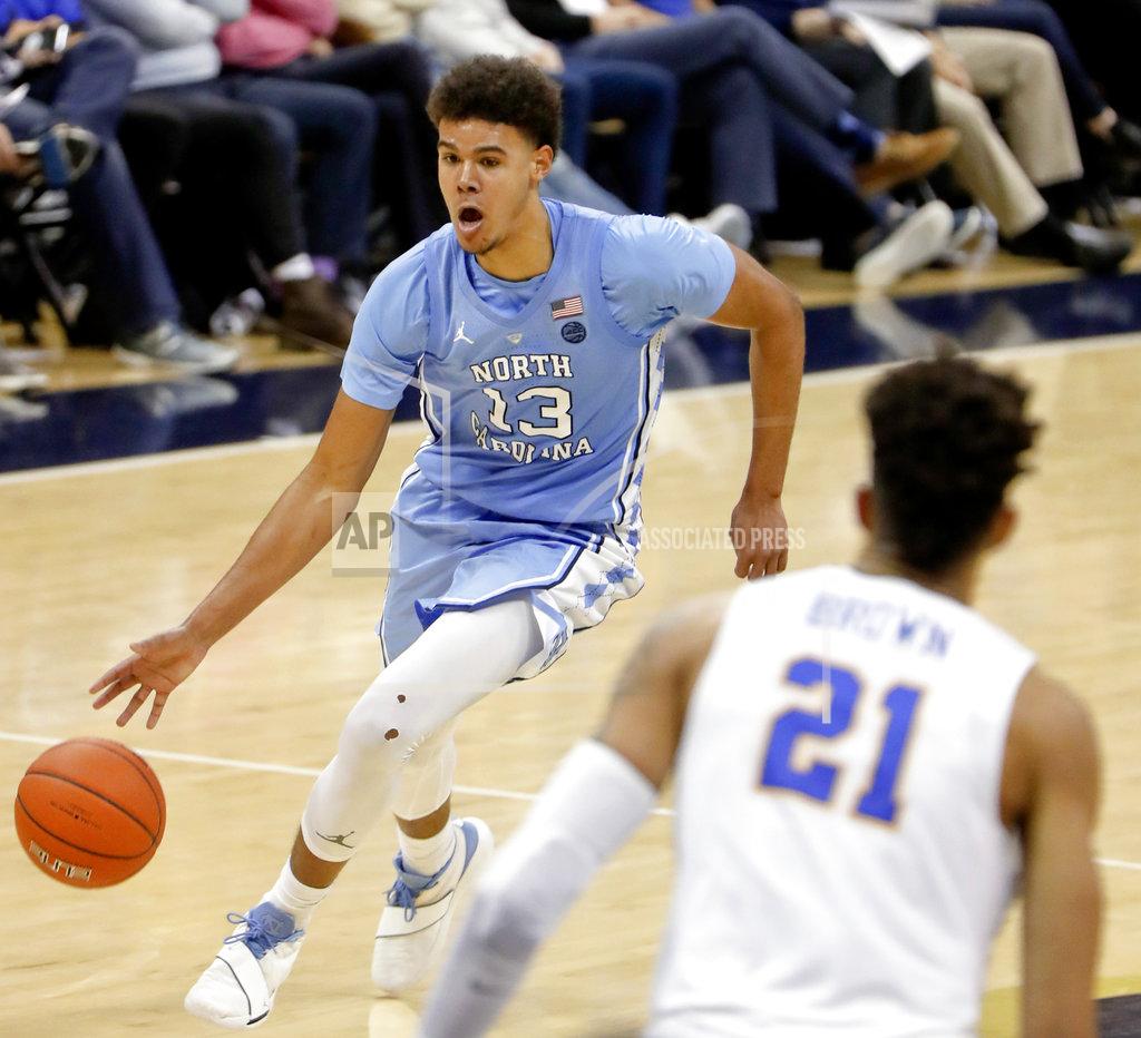 Keith Srakocic North Carolina's Cameron Johnson (13) drives to the hoop as Pittsburgh's Terrell Brown (21) defends during the second half of an NCAA college basketball game, Saturday, Jan. 5, 2019, in Pittsburgh. North Carolina won 85-60. (AP Photo/Keith Srakocic)