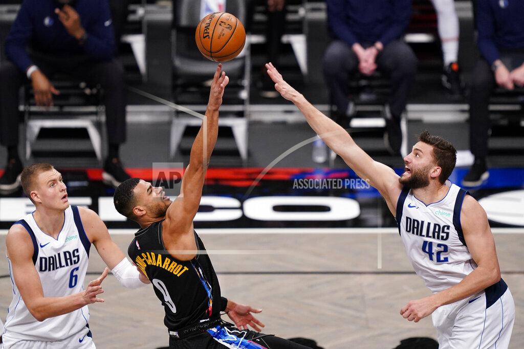 John Minchillo Brooklyn Nets guard Timothe Luwawu-Cabarrot (9) shoots against Dallas Mavericks forward Maxi Kleber (42) during the second half of an NBA basketball game Saturday, Feb. 27, 2021, in New York. (AP Photo/John Minchillo)