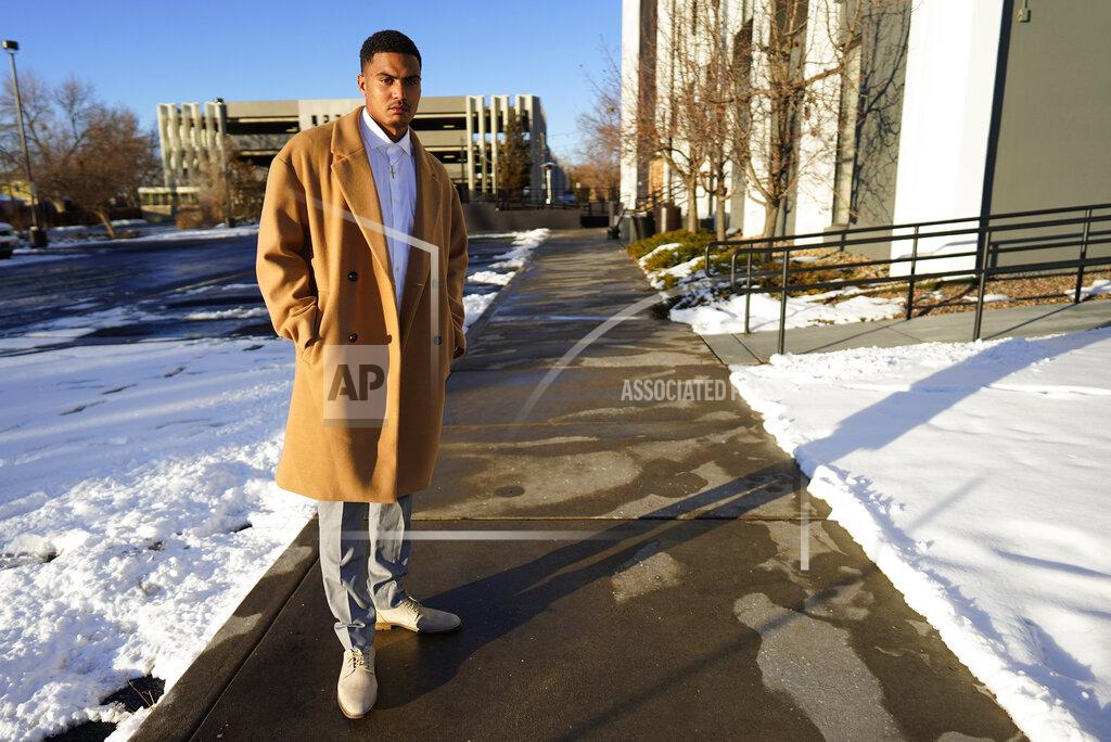 Donte Westmoreland poses for a photo outside a hotel Tuesday, Dec. 15, 2020, in southeast Denver. Westmoreland was recently released from Lansing Correctional Facility in Kansas, where he caught the virus while serving time on a marijuana charge. Some 5,000 prisoners have become infected in Kansas prisons, the second-highest COVID-19 rate in the country, second only to South Dakota. (AP Photo/David Zalubowski)