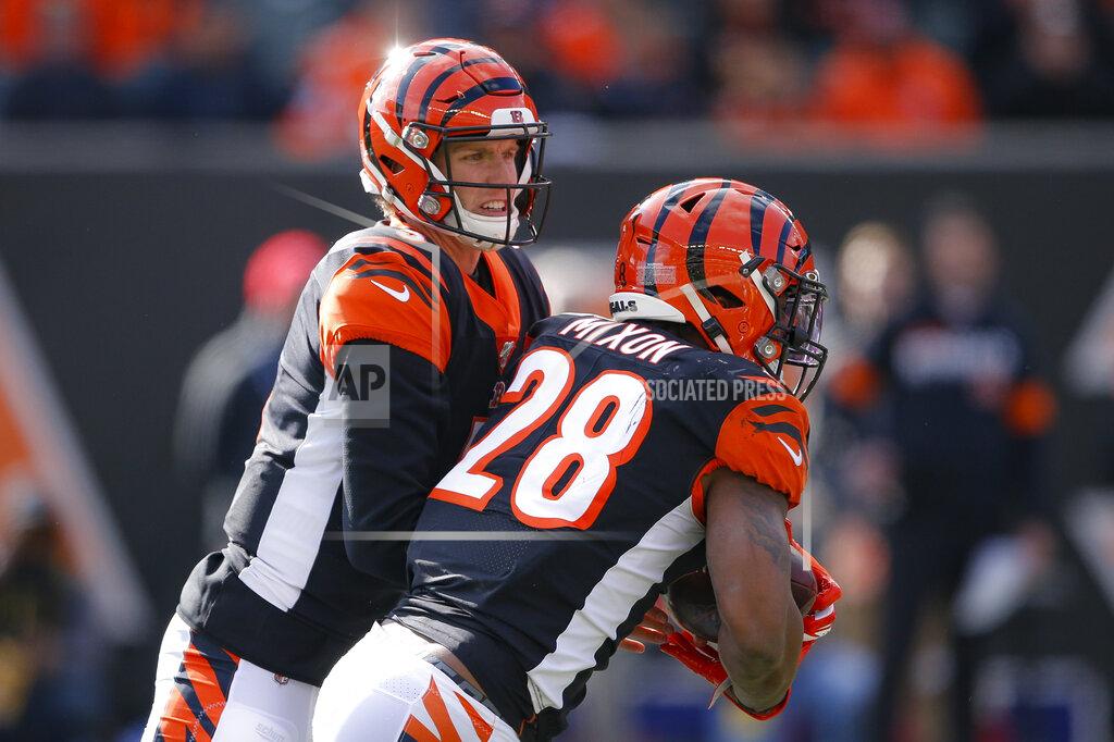 Gary Landers Cincinnati Bengals quarterback Ryan Finley, left, hands off the ball to running back Joe Mixon (28) during the first half an NFL football game against the Pittsburgh Steelers, Sunday, Nov. 24, 2019, in Cincinnati. (AP Photo/Gary Landers)