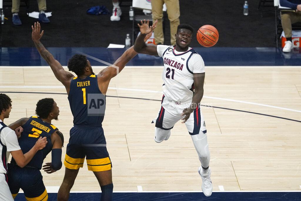 Darron Cummings Gonzaga's Oumar Ballo (21) is fouled by West Virginia's Derek Culver (1) during the second half of an NCAA college basketball game Wednesday, Dec. 2, 2020, in Indianapolis. (AP Photo/Darron Cummings)