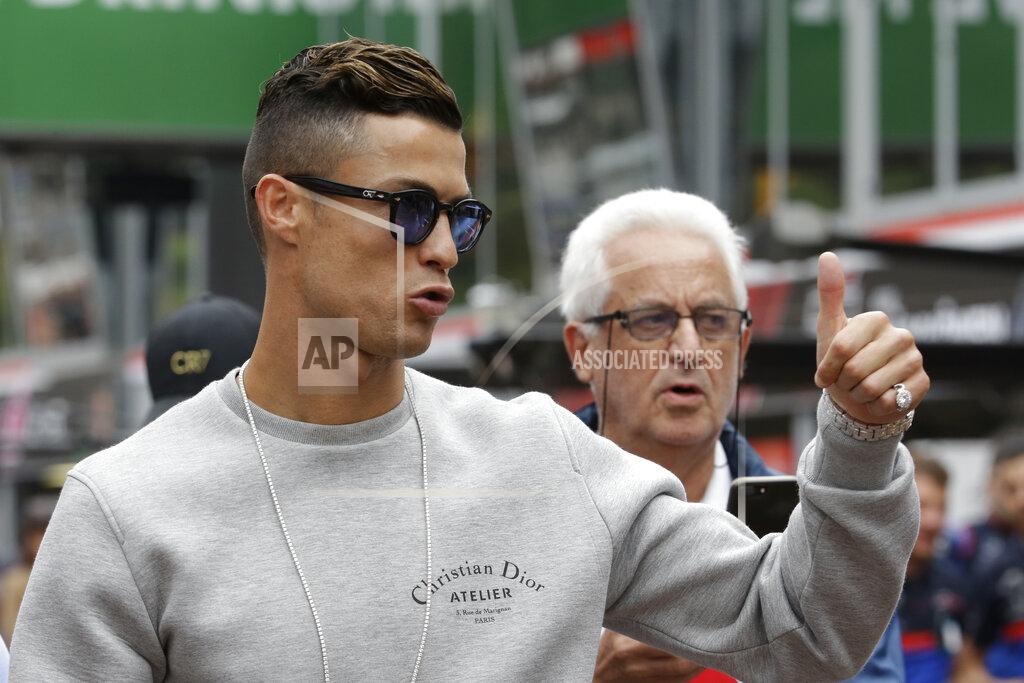 Luca Bruno Cristiano Ronaldo applauds fans at the pit line ahead of the second practice session at the Monaco racetrack, in Monaco, Thursday, May 23, 2019. The Formula one race will be held on Sunday. (AP Photo/Luca Bruno)