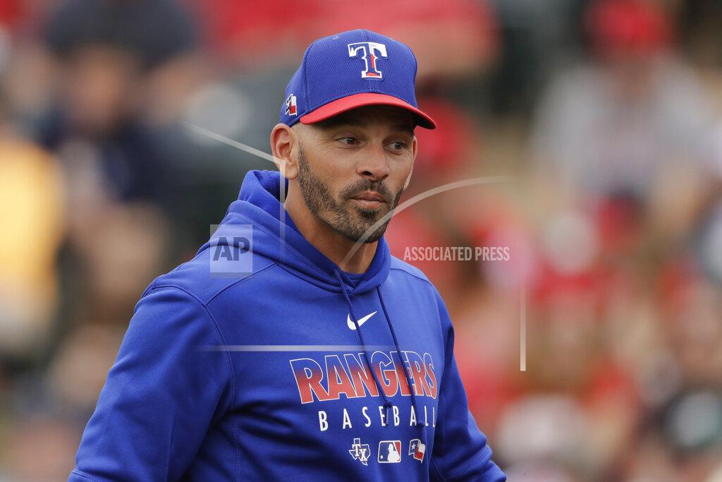Charlie Riedel FILE - In this Friday, Feb. 28, 2020, file photo, Texas Rangers manager Chris Woodward walks back to the dugout after making a pitching change during the third inning of a spring training baseball game against the Los Angeles Angels, in Tempe, Ariz. (AP Photo/Charlie Riedel, File)