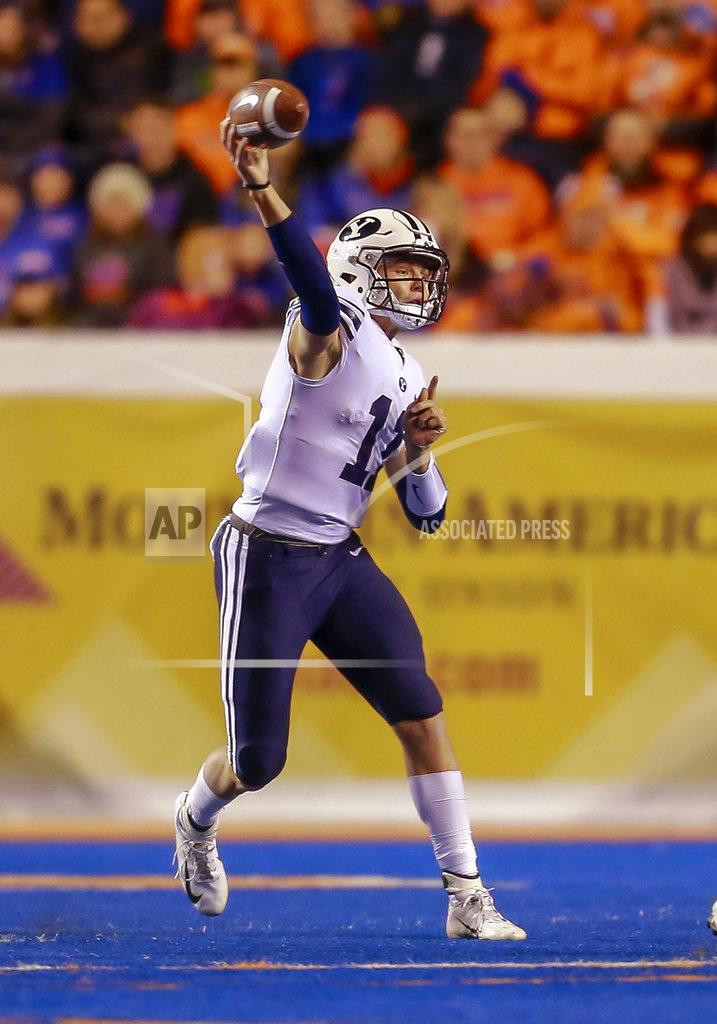 Steve Conner BYU quarterback Zach Wilson (11) throws a pass against Boise State during the first half of an NCAA college football game Saturday, Nov. 3, 2018, in Boise, Idaho. (AP Photo/Steve Conner)