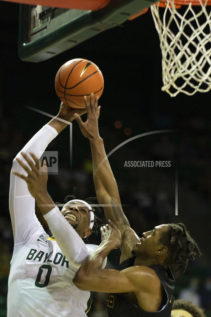 Emil Lippe Baylor forward Flo Thamba (0) attempts a shot over Arkansas-Pine Bluff guard Kylen Milton (1) in the first half of an NCAA college basketball game in Waco, Texas, Saturday, Dec. 4, 2021. (AP Photo/Emil Lippe)
