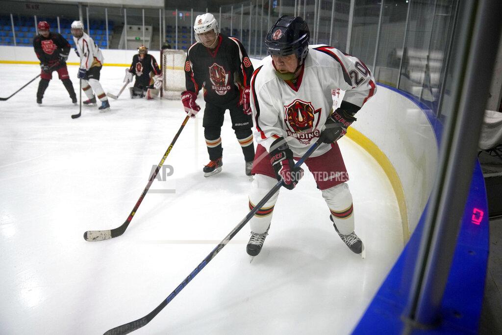 Mark Schiefelbein Members of the "1979" hockey club compete during a hockey match at a rink in Beijing, Wednesday, Jan. 12, 2022. Spurred by enthusiasm after China was awarded the 2022 Winter Olympics, the members of a 1970s-era youth hockey team, now around 60 years old, have reunited decades later to once again take to the ice. (AP Photo/Mark Schiefelbein)