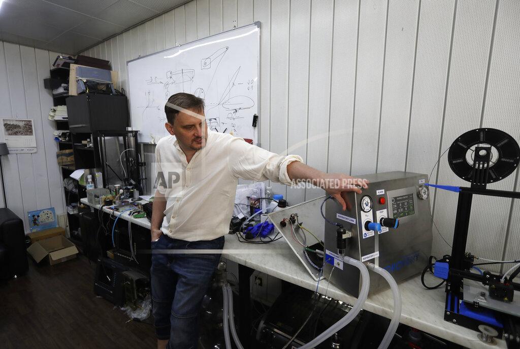Tomas Kapler, an IT expert, talks about a lung ventilator "Corovent" in Prague, Czech Republic, Monday, June 15, 2020. A group of volunteers in the Czech Republic was working round the clock to prevent critical shortage of ventilators for COVID-19 patients. Led by Tomas Kapler, a team of 30 developed a fully functional ventilator _ named Corovent _ in just days. They secured the necessary finances through crowdfunding, approached a leading expert in the field with a request for help and gave him all possible support. (AP Photo/Petr David Josek)