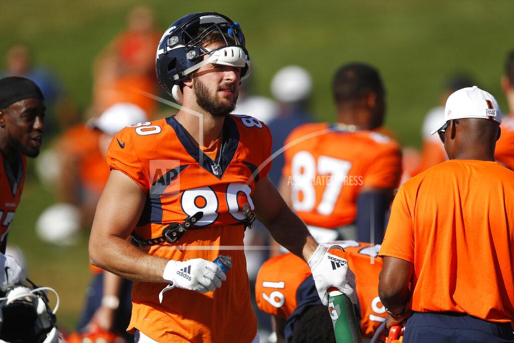 Denver Broncos tight end Jake Butt grabs a water bottle during a combined NFL training camp with the San Francisco 49ers Saturday, Aug. 17, 2019, at the Broncos' headquarters in Englewood, Colo. (AP Photo/David Zalubowski)