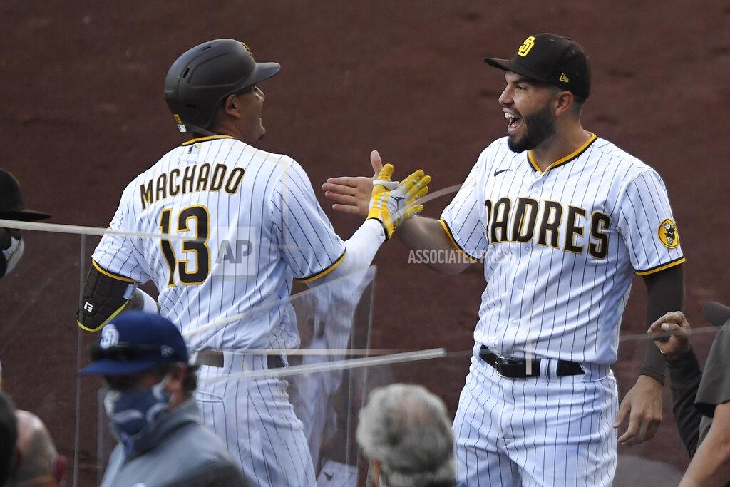 Denis Poroy San Diego Padres' Manny Machado, left, is congratulated by Eric Hosmer after hitting a solo home run during the first inning of the team's baseball game against the Arizona Diamondbacks on Saturday, April 3, 2021, in San Diego. (AP Photo/Denis Poroy)