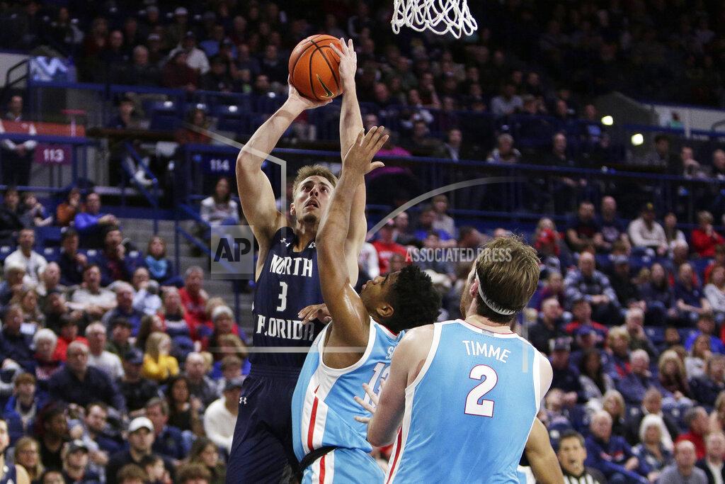 Young Kwak North Florida forward Carter Hendricksen, left, shoots while defended by Gonzaga guard Malachi Smith, center, during the first half of an NCAA college basketball game, Monday, Nov. 7, 2022, in Spokane, Wash. (AP Photo/Young Kwak)