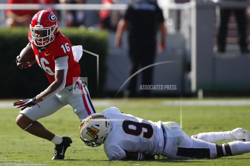 Joshua L. Jones Georgia quarterback John Seter (16) tries to break a tackle from Murray State defensive back Dior Johnson (9) during the first half of an NCAA college football game Saturday, Sept. 7, 2019, in Athens, Ga. (Joshua L. Jones/Athens Banner-Herald via AP)