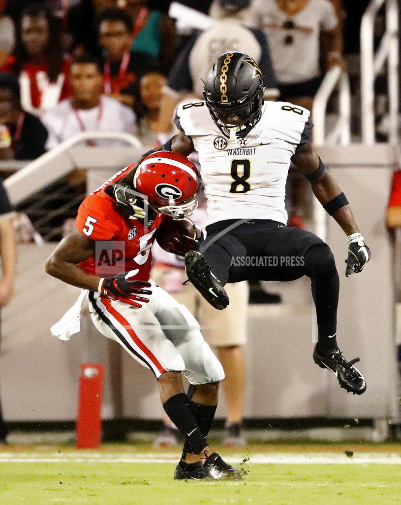 John Bazemore Georgia wide receiver Terry Godwin (5) gets away from Vanderbilt cornerback Joejuan Williams (8) to score a touchdown after catching a pass from quarterback Jake Fromm during the first half of an NCAA college football game Saturday, Oct. 6, 2018, in Atlanta. (AP Photo/John Bazemore)