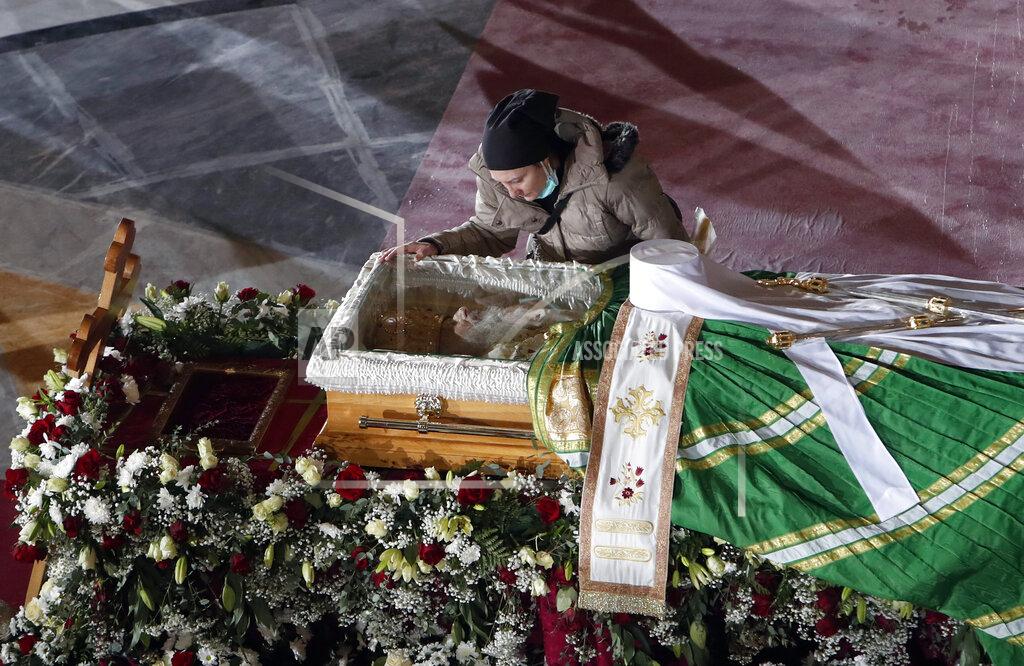 Darko Vojinovic FILE - In this Saturday, Nov. 21, 2020 file photo, a woman mourns at the coffin of Patriarch Irinej as he lies in repose at the St. Sava Temple in Belgrade, Serbia. Patriarch Irinej died after testing positive for the coronavirus. He was 90. (AP Photo/Darko Vojinovic)