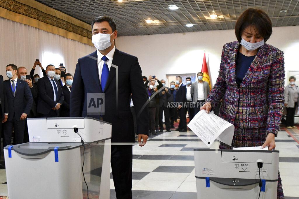 Vladimir Voronin Kyrgyzstan's President Sadyr Japarov and his wife Aigul Asanbaeva cast their ballots at a polling station during the referendum in Bishkek, Kyrgyzstan, Sunday, April 11, 2021. Voters in Kyrgyzstan cast ballots Sunday on whether to approve a new constitution that would substantially increase the president's powers. The Sunday referendum comes three months after Sadyr Zhaparov was elected president, following the ouster of the previous president amid protests, the third time in 15 years that a leader of the Central Asian country had been driven from office in a popular uprising. (AP Photo/Vladimir Voronin)