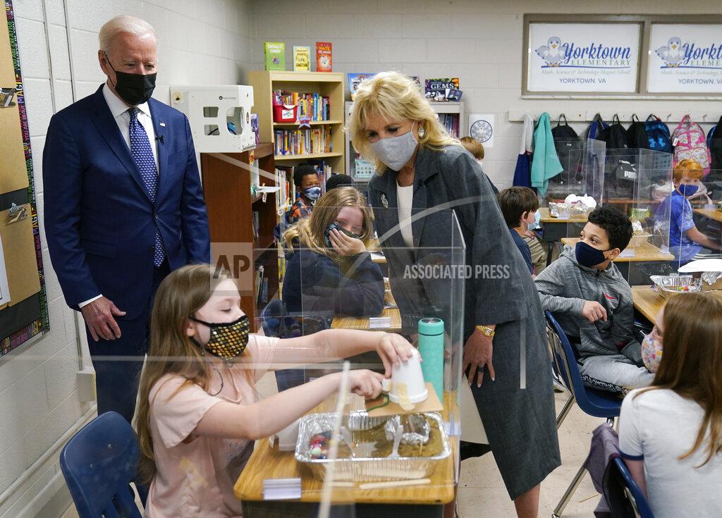 Evan Vucci President Joe Biden and first lady Jill Biden, watch a student demonstrate her project, during a visit to Yorktown Elementary School, Monday, May 3, 2021, in Yorktown, Va. (AP Photo/Evan Vucci)